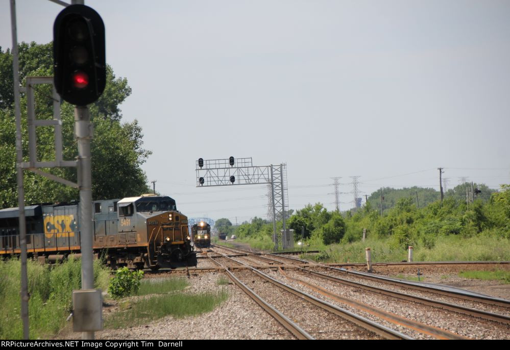 CSX 5491 leads M326 across the diamond as NS 6703 waits